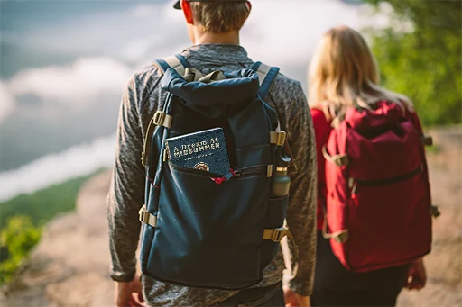 A Dream at Midsummer in the side pocket of a hiking backpack