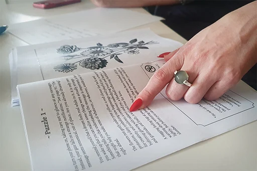A reader's finger tracing Puzzle 1 in A Dream at Midsummer